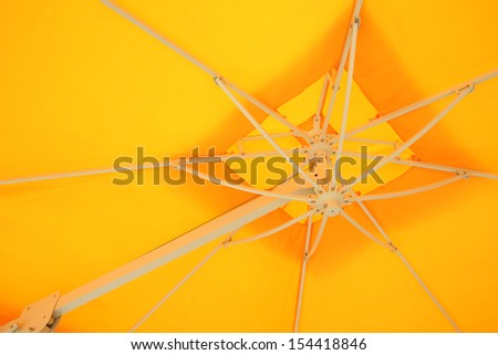 Under yellow umbrella.