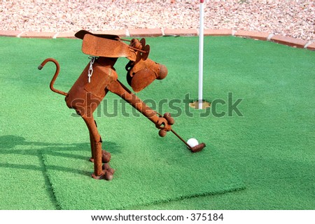 Rusty tin dog playing golf.