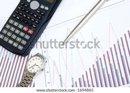 pen, calculator on a chart