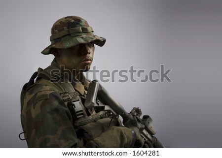 jungle soldier in the army dressed in camo front view