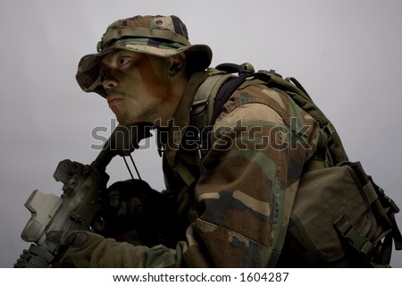 jungle soldier in the army dressed in camo side view