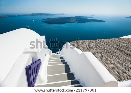 Stairs leading down to the sea. White architecture on Santorini island, Greece. Beautiful view on the sea