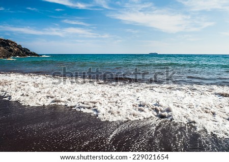 View of the seacoast and the beautiful Red beach. Santorini island, Greece. Black volcanic sand
