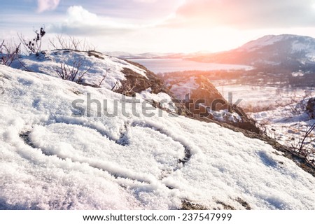 Heart on the snow Winter landscape in the mountain at sunset Heart on the snow Winter landscape in the mountain at sunset