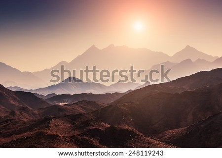 Fantastic landscape with mountains at sunset. Arabian desert, Egypt. Beautiful nature. Creative toning effect