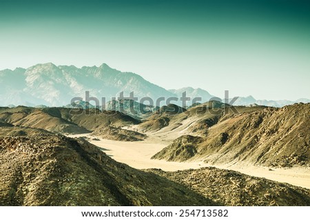 Beautiful mountains in the Arabian desert at sunset. Summer landscape. Vintage effect