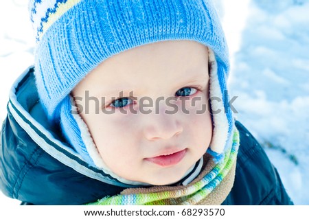 Portrait of a child with blue eyes in a winter setting