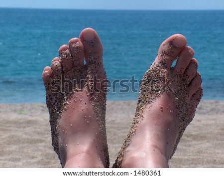 stock photo Young girls feet on a beach