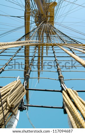 rope ladder to the main mast of the ship on blue sky background