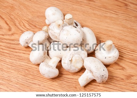 Champignons mushrooms on wood texture background