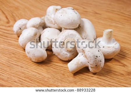 Champignons mushrooms on wood texture background