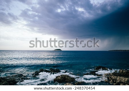 Dark stormy sunset and clouds at sea