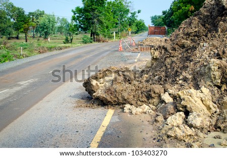Broken road by an flood or landslide (road sign), Thailand.