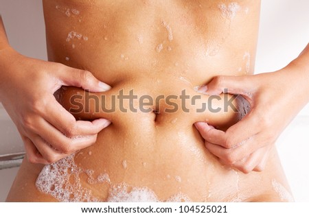 body of beautiful young asian female in bath tub with liquid soap