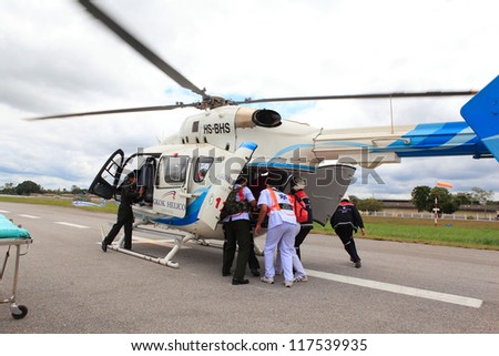 KORAT, THAILAND - SEP 15 : Bangkok Hospital Rescue team(white) pulling cart with wounded person to helicopter in Search and Rescue Exercise(SAREX) on September 15, 2012 in Nakhonratchasima,Thailand