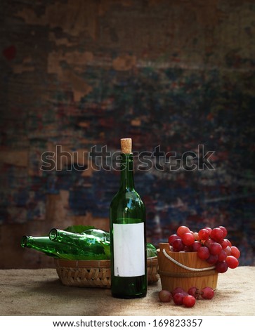 Still life art photography via day light on old pale bottles with wine grape fruit
