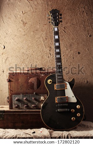 Still life art photography of vintage electric guitar and rare vintage amplifier on grunge background