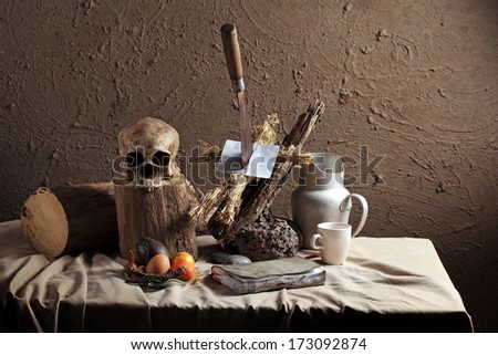 Still Life Art Photography Concept On Voodoo Straw Doll Stuck With Knife On Wood Log And Skull With Black Accessories