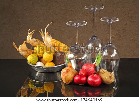 Still life art photography of mixed vegetables with up side down wine glasses