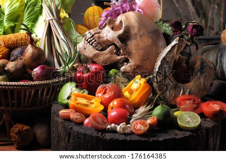 Still life fine art on green concept mixed vegetables with skull