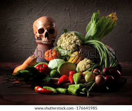 Still life fine art photography on raw mixed vegetables with skull