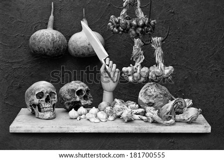 Still life art photography on human skull calabash bottle Gourd onions and pumpkins on grunge background black and white version