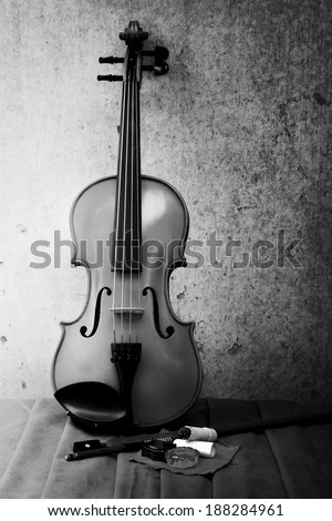 Still life art photography on violin bow and rosin on grunge background black and white version