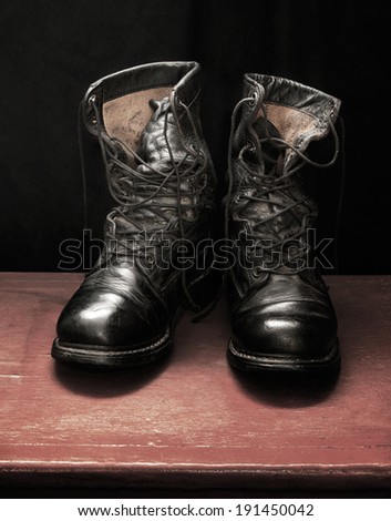Still life art photography on military concept with boots and wood