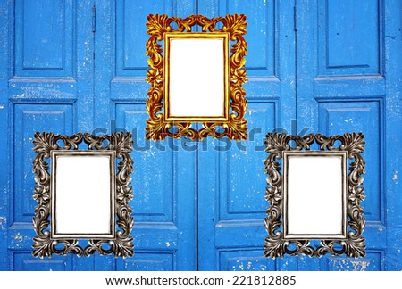 Vintage blue Greek door with gold and silver frames