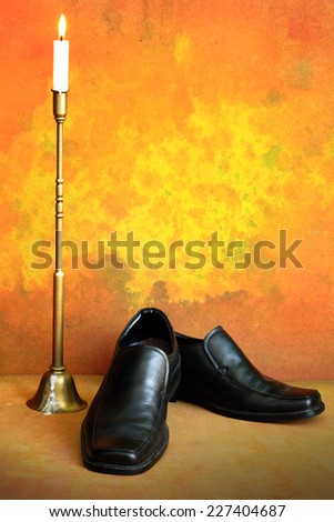 Gentleman shoes with candlestick on grunge background still life art photography