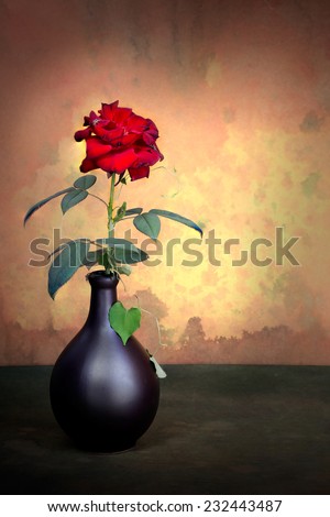 Red rose in brown vase on grunge still life style