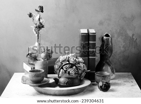 Still life art photography with books roses on marble table black and white version