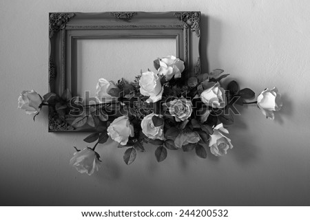 Valentines day empty picture frame and roses bouquet corner black and white