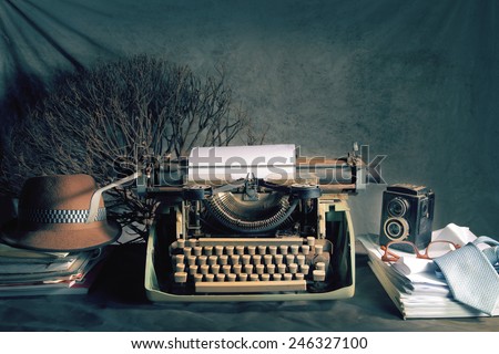 Vintage still life on reporter concept with old typewriter and retro twin lens reflex camera