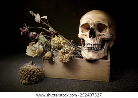 Still life art on skull and bouquet in box