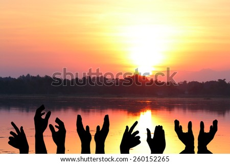 hands silhouette over sunset