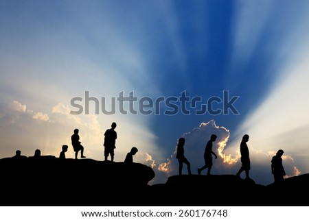 shadow people climbing on hill cliff