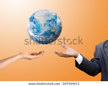 Man woman hands palm up with global image over orange shade Elements of this image furnished by NASA