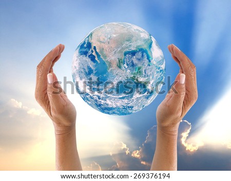 Human hands protect global Earth image  over gas clouds and Sun a Think Earth Concept Elements of this image furnished by NASA