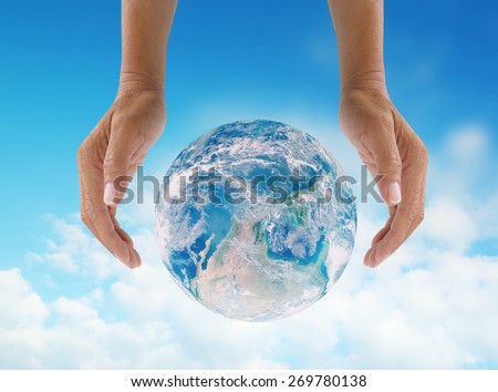 Human hands protect global Earth NASA image  over gas clouds and Sun a Think Earth Concept