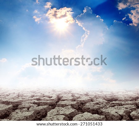 Hot bright sun over cloudy sky with broken land soil