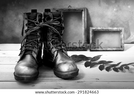 High resolution still life art photography on jungle boots and wood frame black and white version