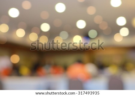 Lens blur on crowd sitting in convention room