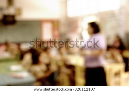 Young female teacher in front of classroom instruct social business and internet content and class activity for young students raise up hands