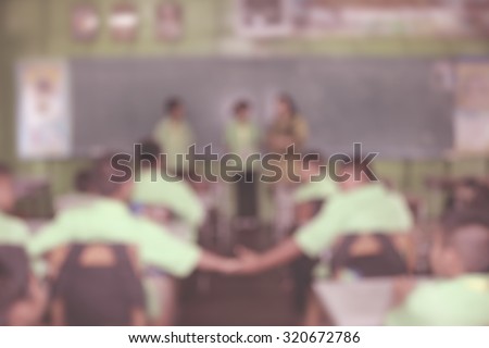 Female school teacher in classroom with boys and girls student