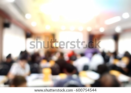 Education concept, blurred students studying in large hall with screen and projector for showing information people teacher room presentation