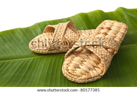 handmade slippers from dry water hyacinth on green banana leaf for indoor usage