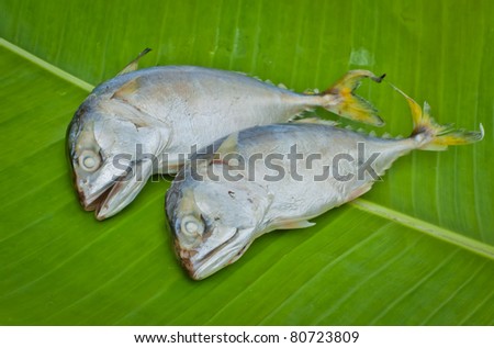 two boiled mackerel fish on green banana leaf