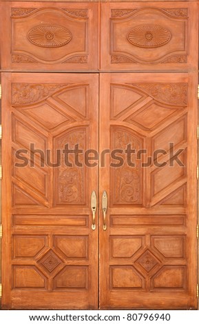 crafted wood door at Buddha temple in Thailand