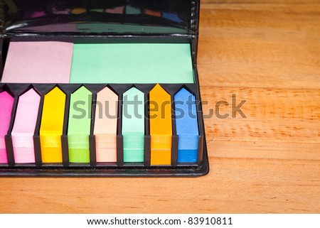 Multicolored post it note block in black leather case